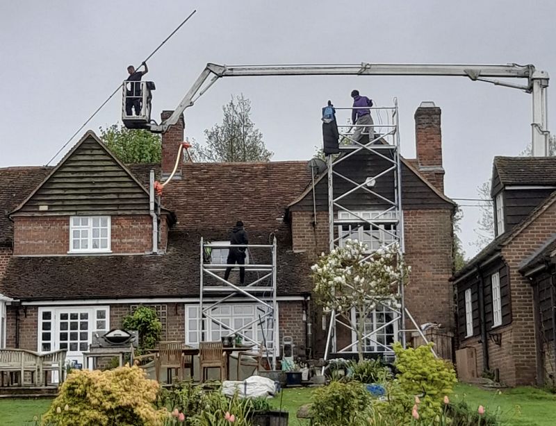 The Roof Moss Cleaners using cherry picker and scaffolding to clean roof safely and professionally in Kettering, Northamptonshire