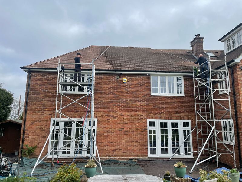 Roof cleaning carried out safely from scaffold towers by The Roof Moss Cleaners in Kettering